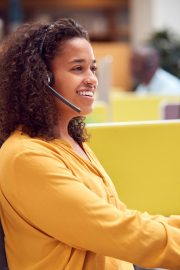 businesswoman-wearing-phone-headset-talking-to-cal-2021-12-09-06-50-59-utc 1